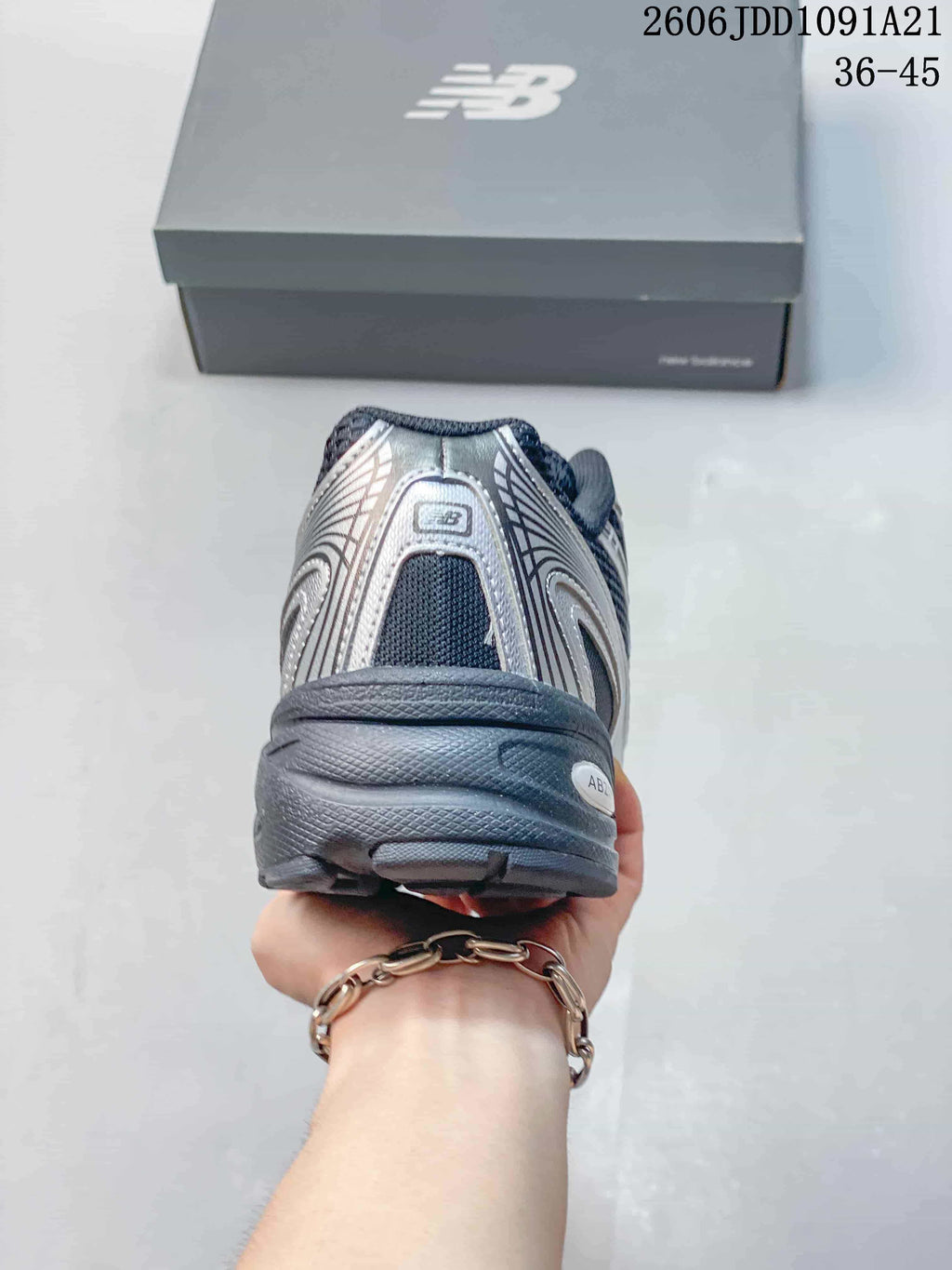 Rear view of a New Balance 740 sneaker with navy mesh and silver-toned overlays