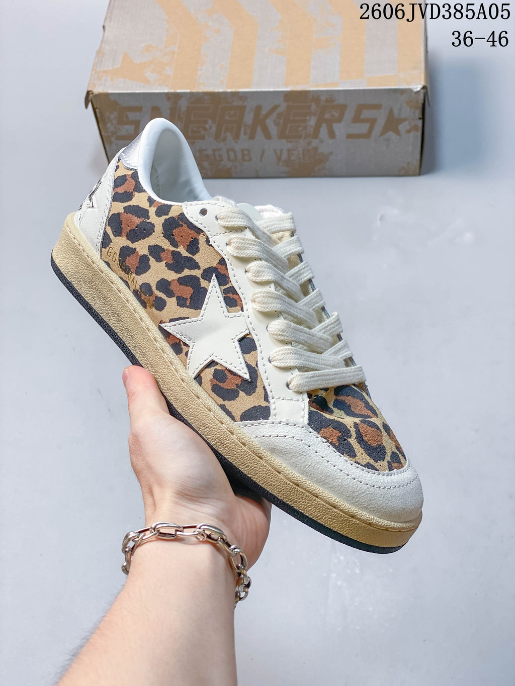 Side and front view of a leopard-print sneaker with a cream star and distressed-look sole.