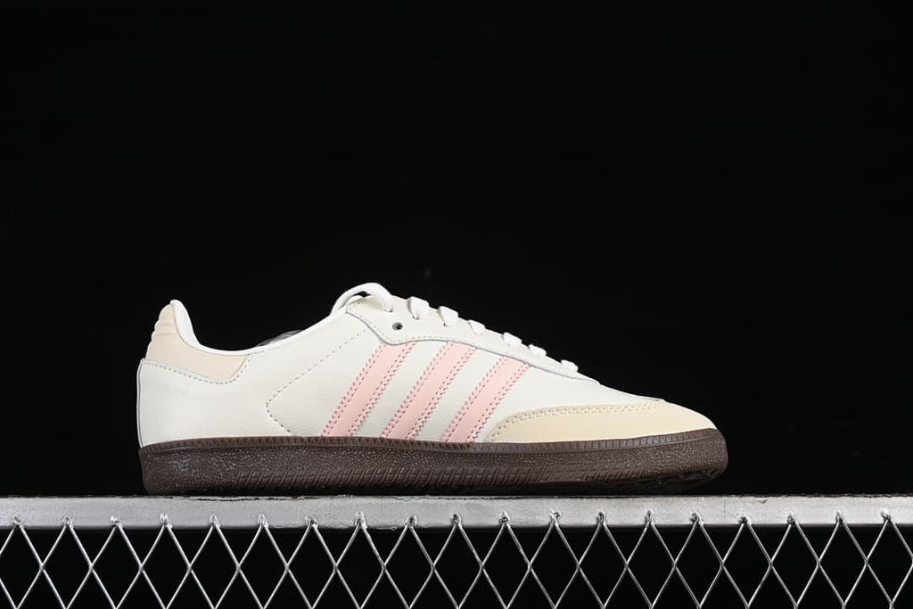 Side profile showing pink stripes and a dark gum-style sole