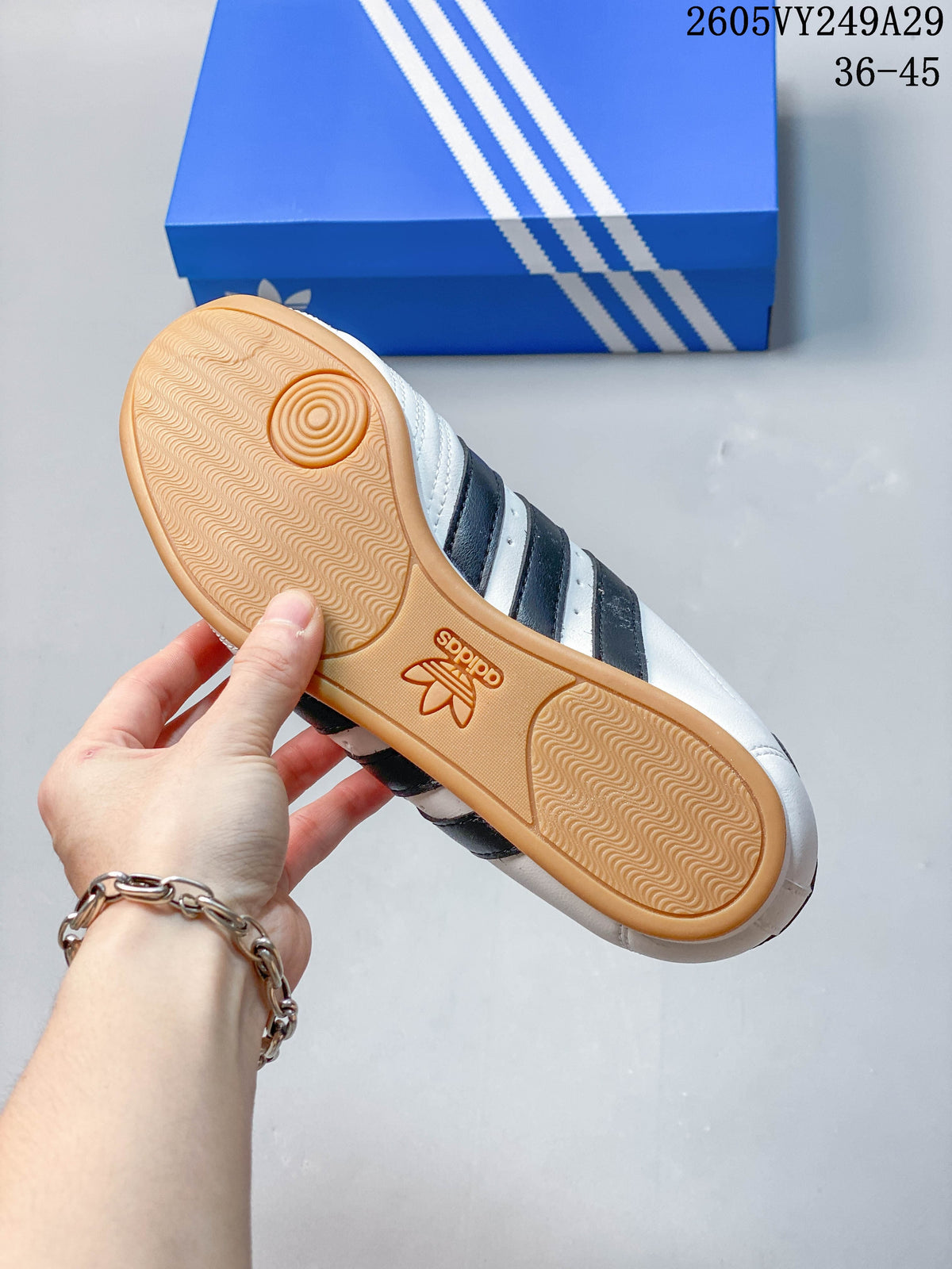 Textured gum-colored outsole of a white adidas Taekwondo sneaker
