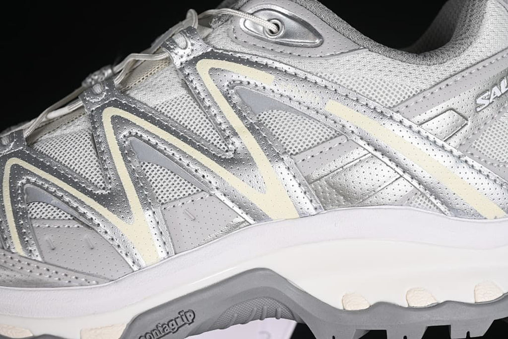 Close-up of the silver-gray side panels, overlay design, and outsole.