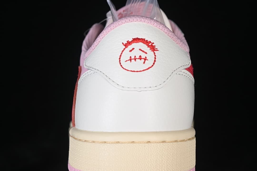 Rear view showing embroidered red heel graphics.