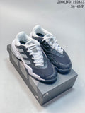 Pair of gray, charcoal, and white Adidas Barricade 13 tennis shoes on a shoebox