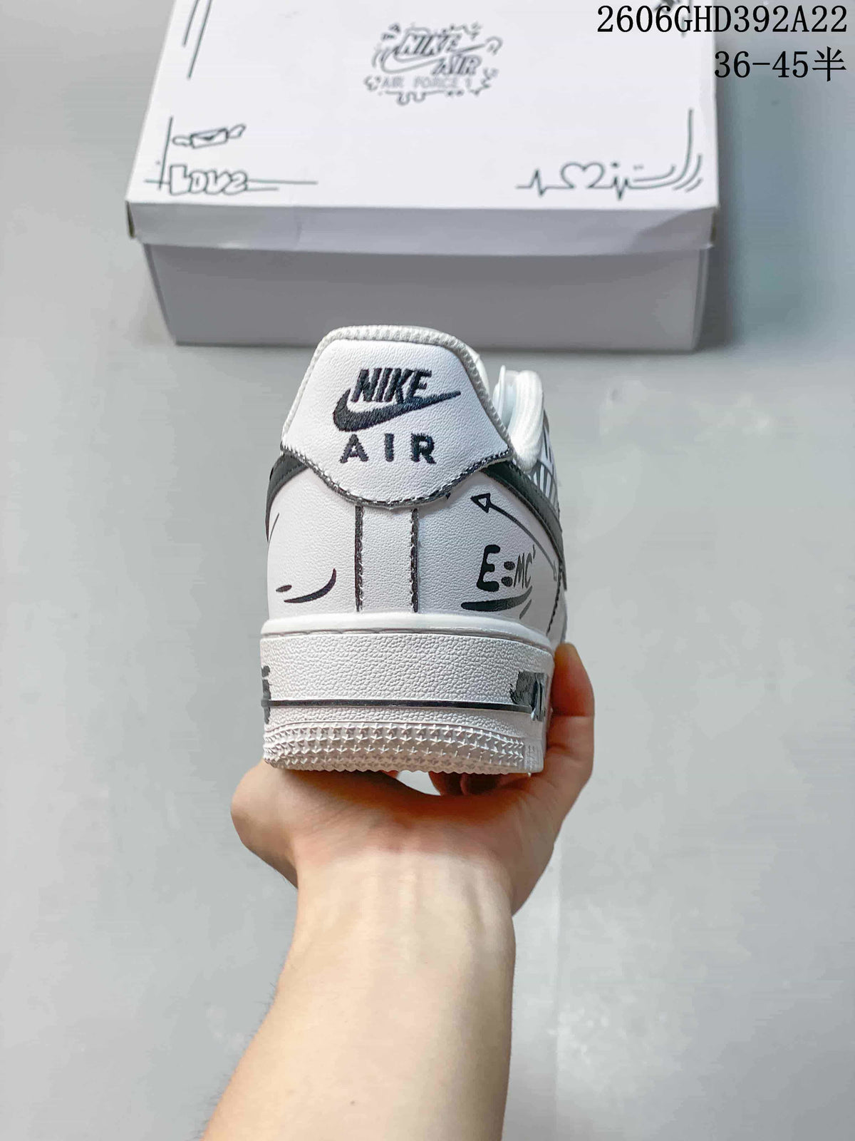 Rear view of the white sneaker with Nike Air branding and black graphic accents.