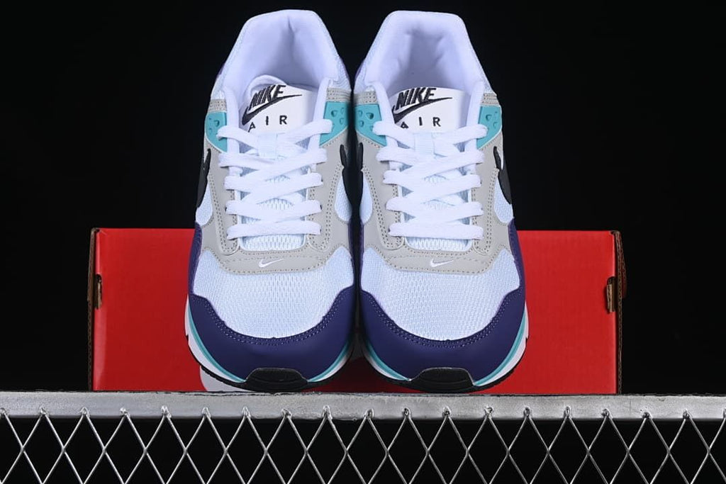 Front view of the pair showing white mesh toes and purple and turquoise accents