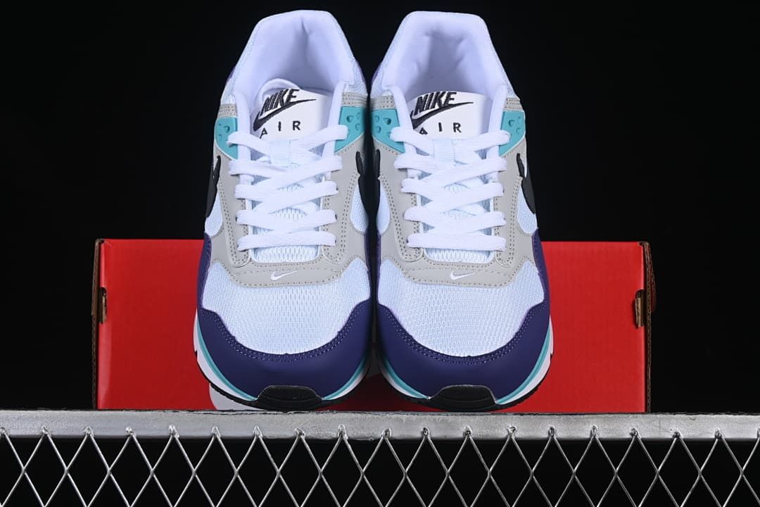 Front view of the pair showing white mesh toes and purple and turquoise accents