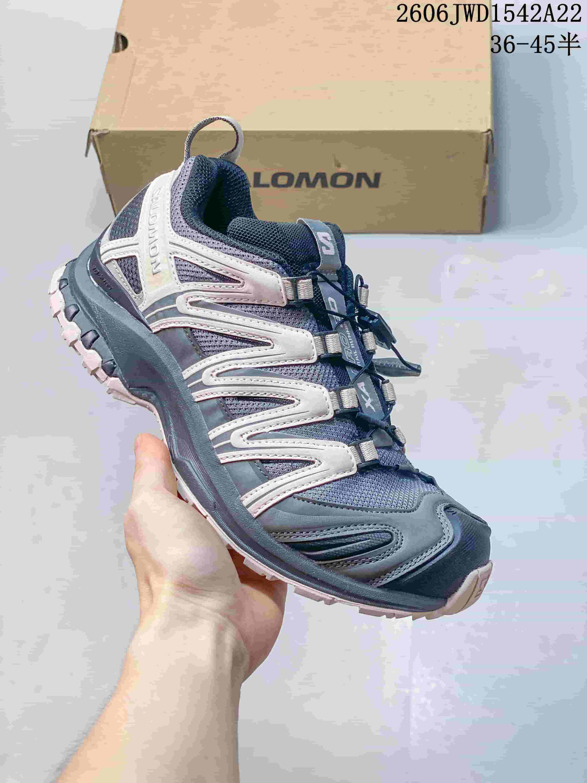 Side profile of a navy, gray, and pale pink Salomon XA Pro sneaker