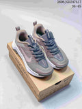 Nike Wildhorse 10 trail running shoes in gray and muted pink, shown from the front on a Nike Trail box
