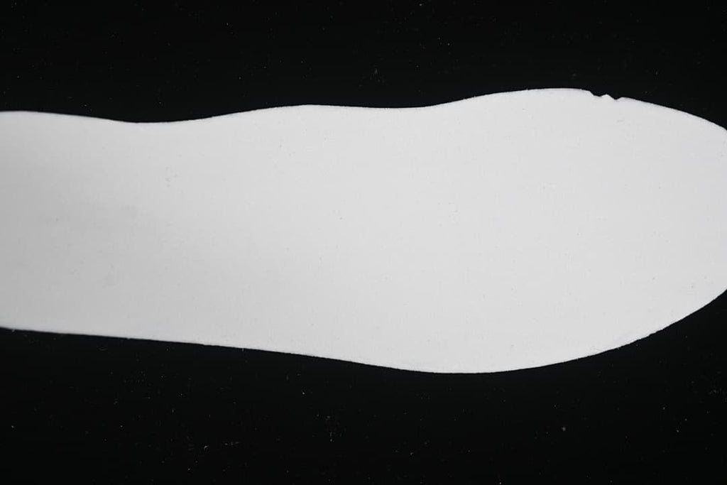 White shoe-shaped insert shown against a black background