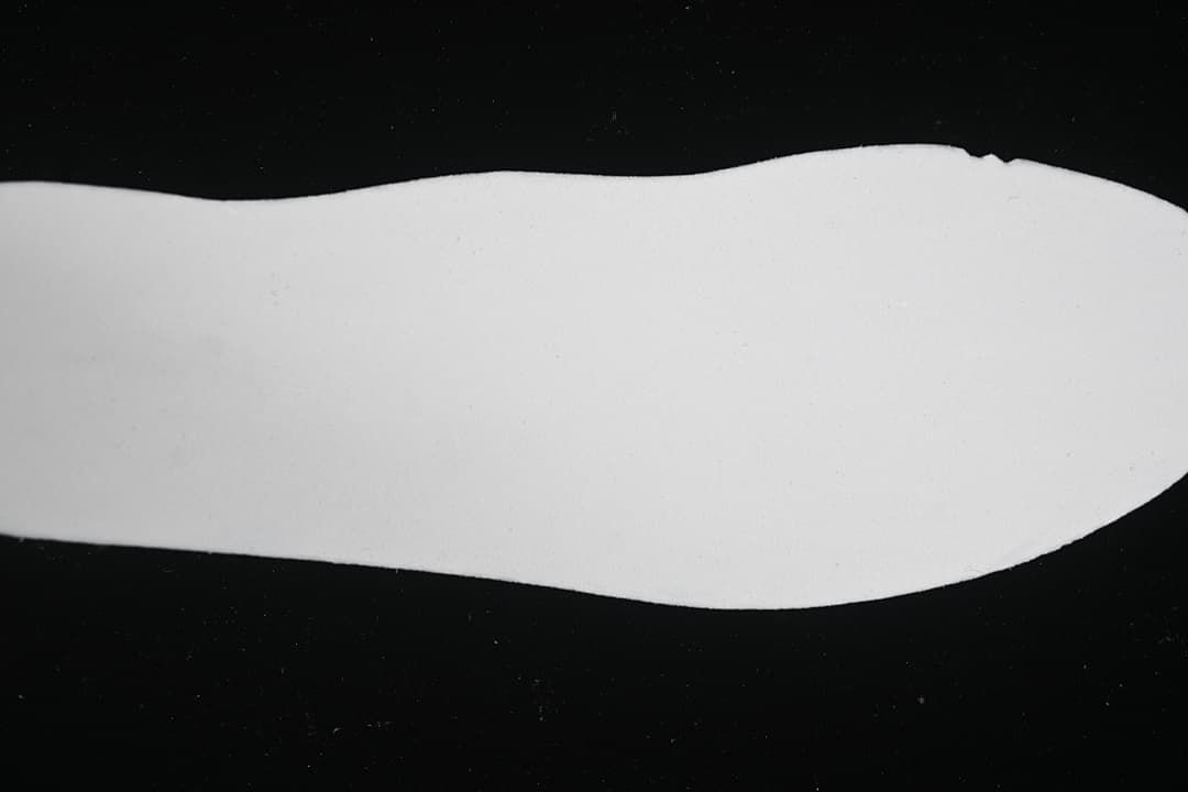 White shoe-shaped insert shown against a black background