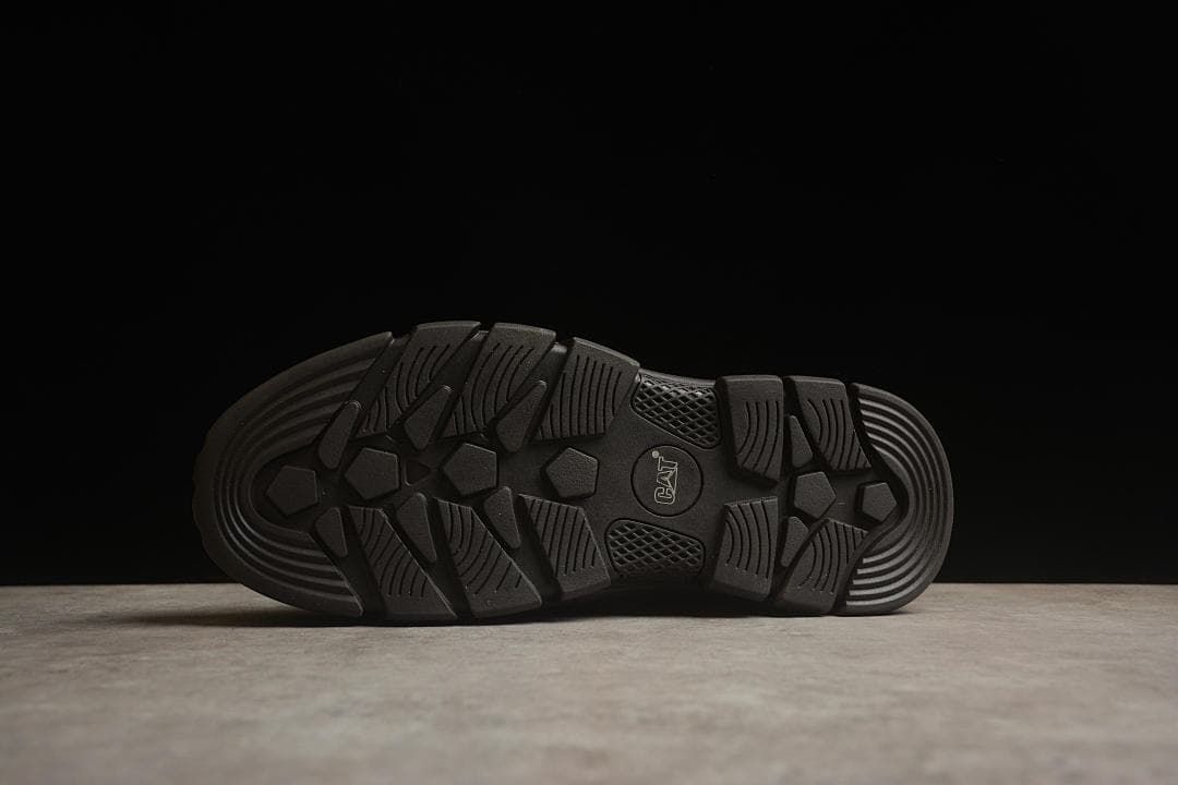 Underside view of the dark outsole with its patterned tread.