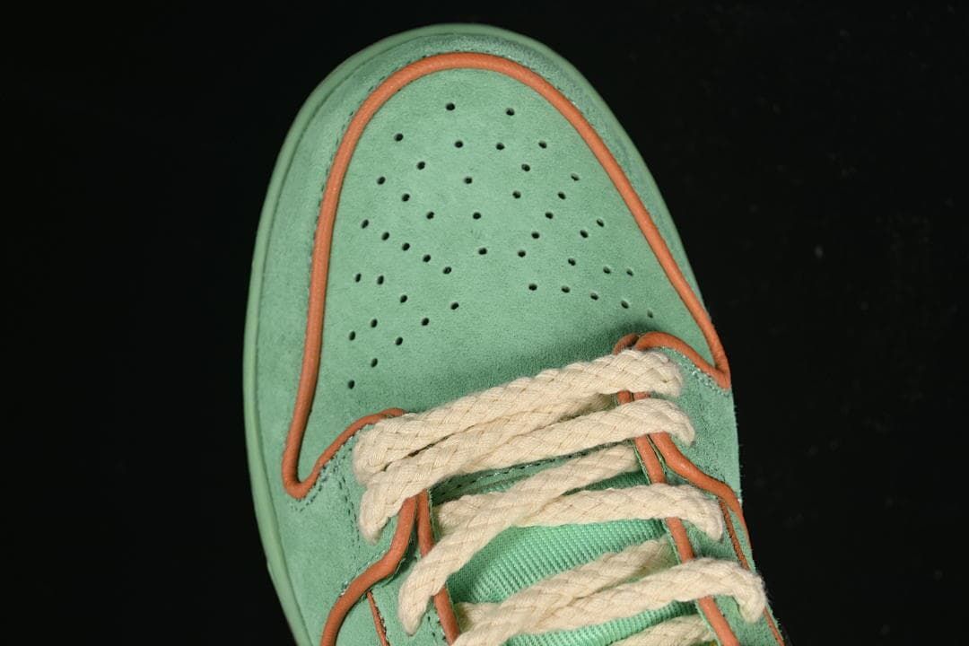 Top view of the perforated mint green toe and thick cream-colored laces.