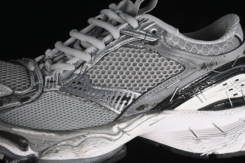 Close-up of grey mesh-look panels, laces and sculpted sole