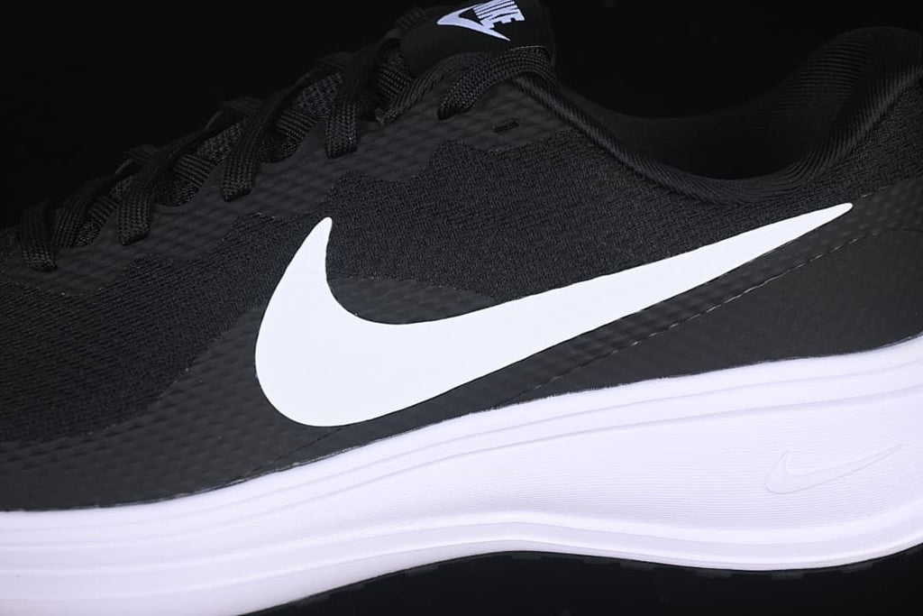Close-up side view of the white Swoosh, black upper and white midsole
