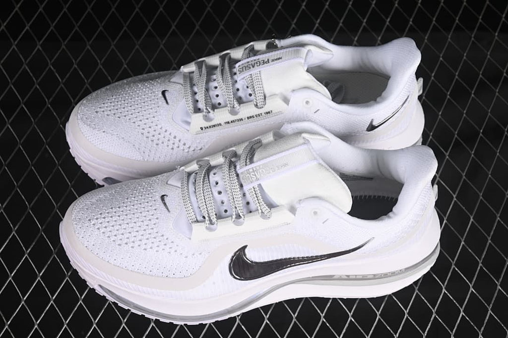 Pair of white running shoes shown from above at an angle.
