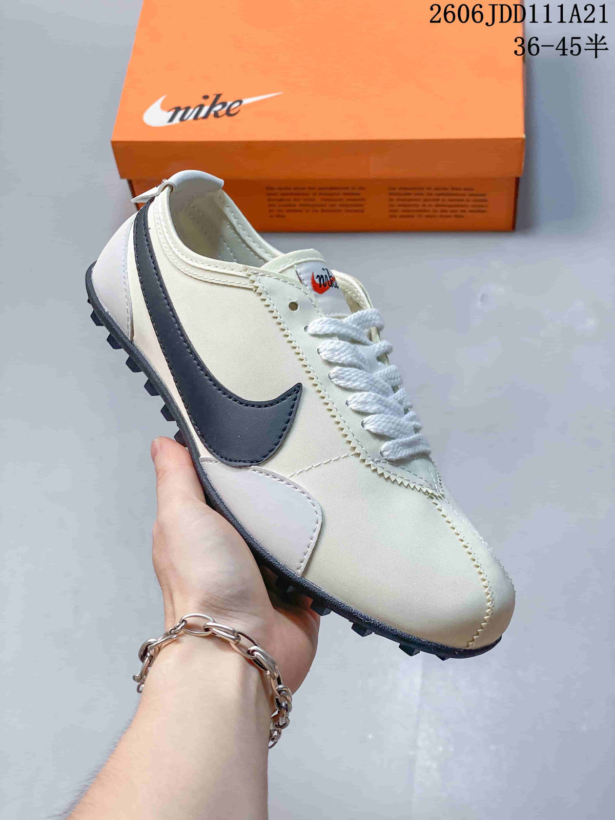 Angled side view of an off-white Nike Moon Shoe OG Summit sneaker with a dark Swoosh
