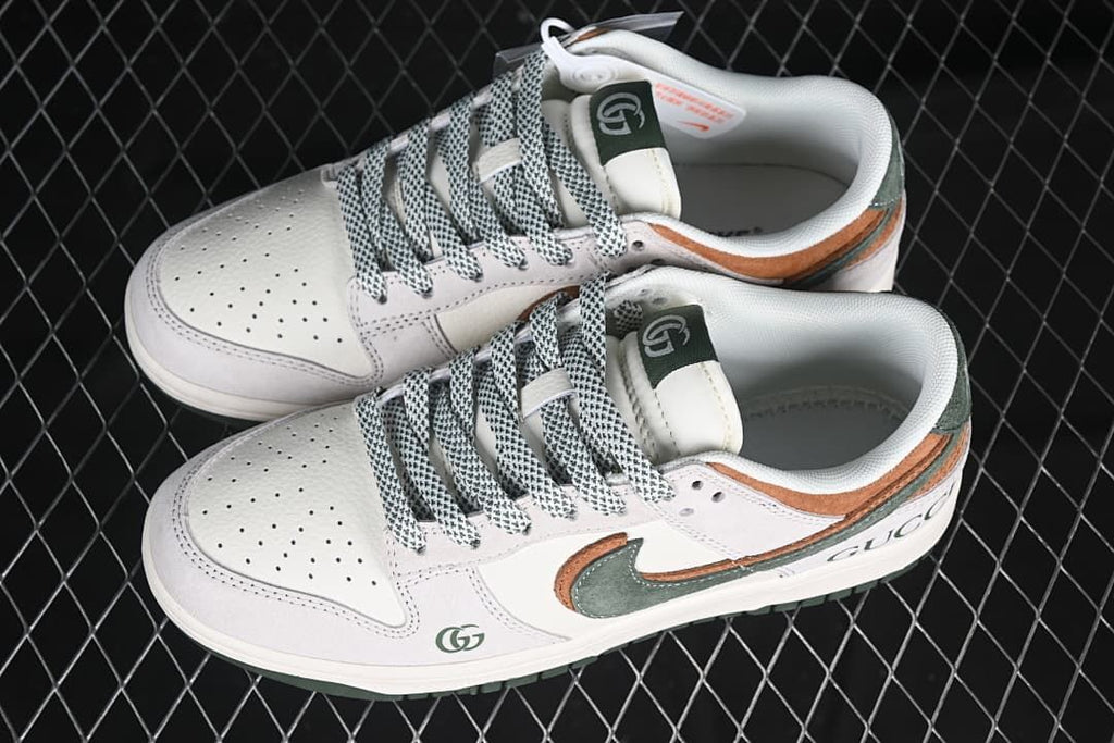 Pair of off-white low-top sneakers with brown and green details