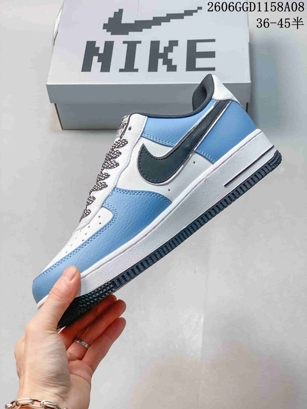 Side view of a white and light blue sneaker with a dark side accent