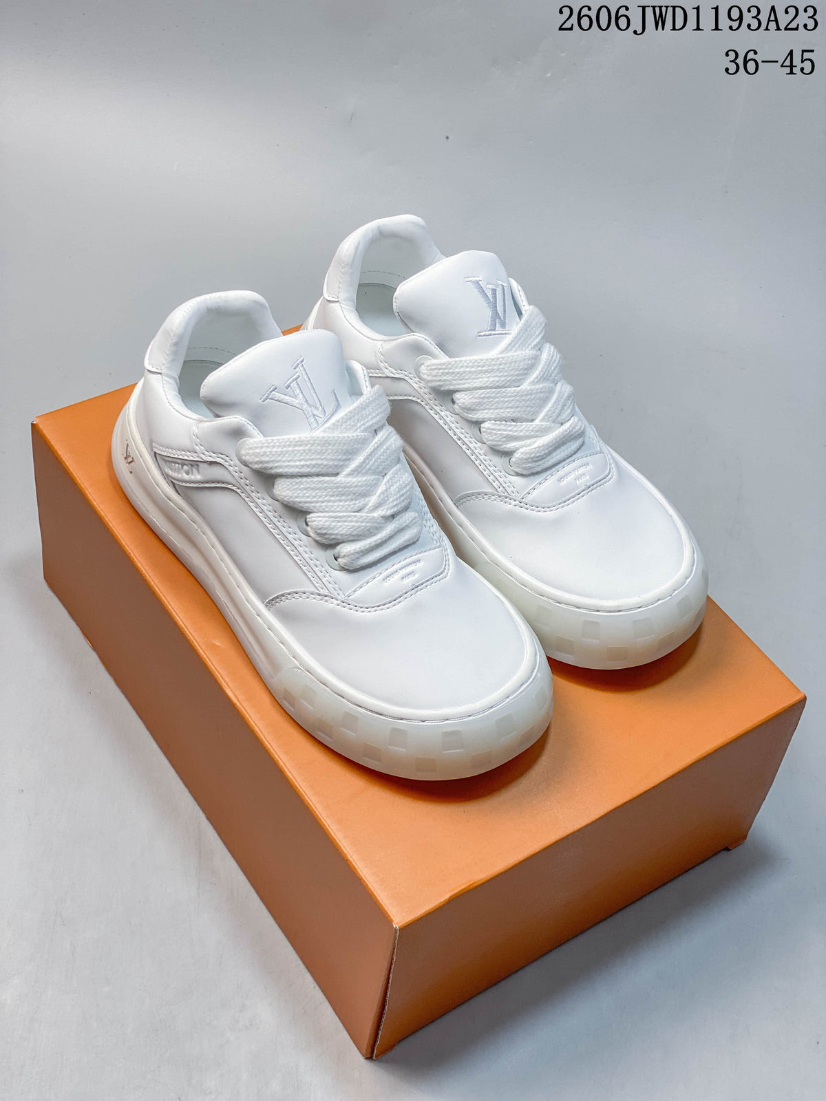 Pair of white Louis Vuitton Tilted low-top lace-up sneakers on an orange shoe box