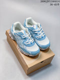 Blue and white ASICS GEL-NYC sneakers shown from above on a shoebox.