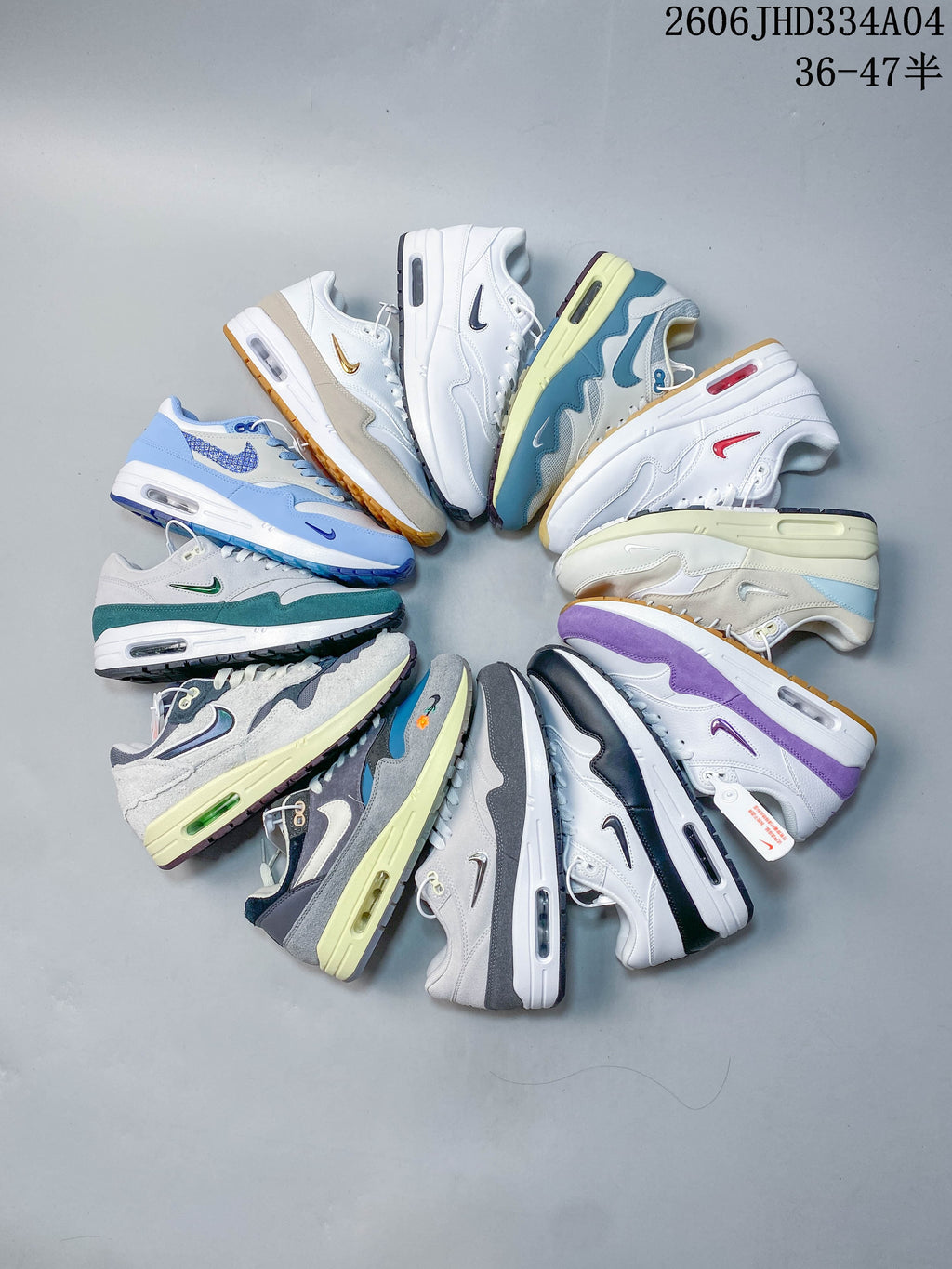 White Nike Air Max 1 sneaker with dark teal overlays and a reflective green Swoosh.