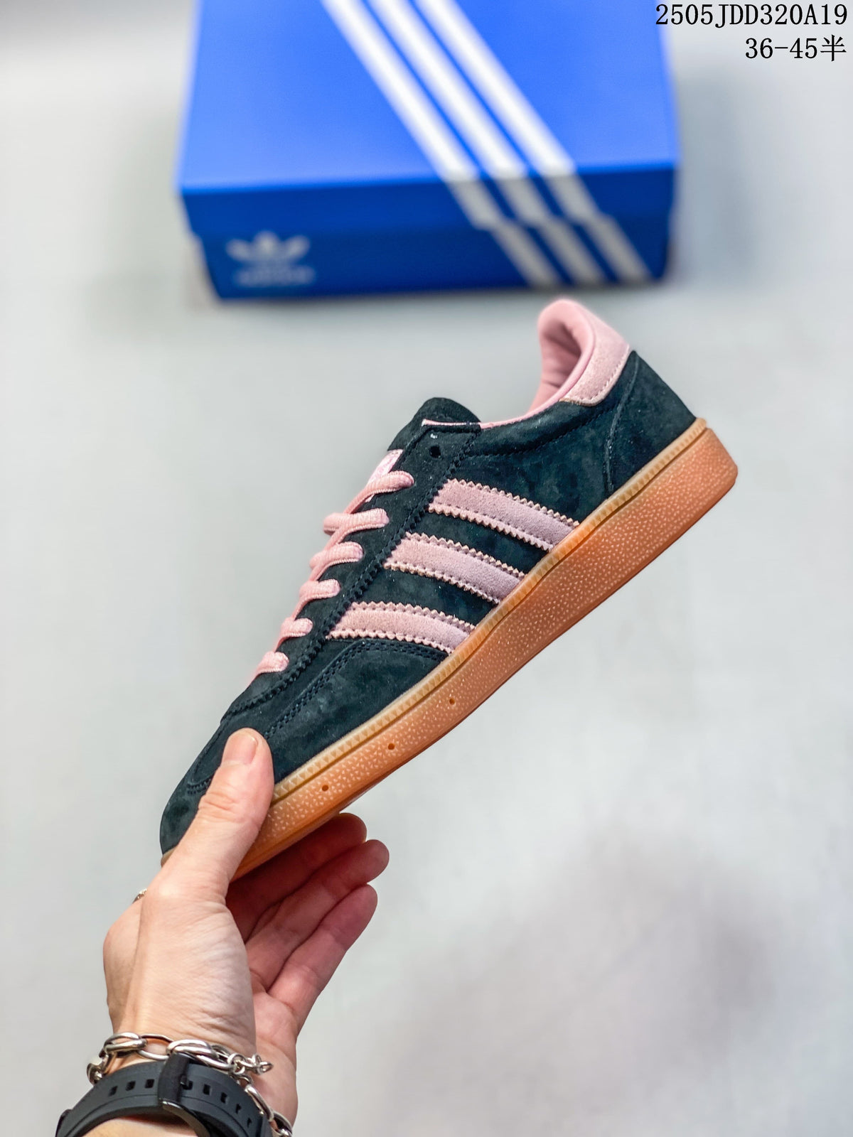 Side view of a navy sneaker with pink stripes and a gum-colored sole