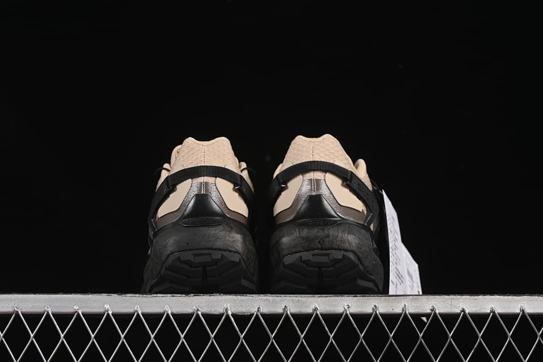 Rear view of both shoes and their treaded soles.