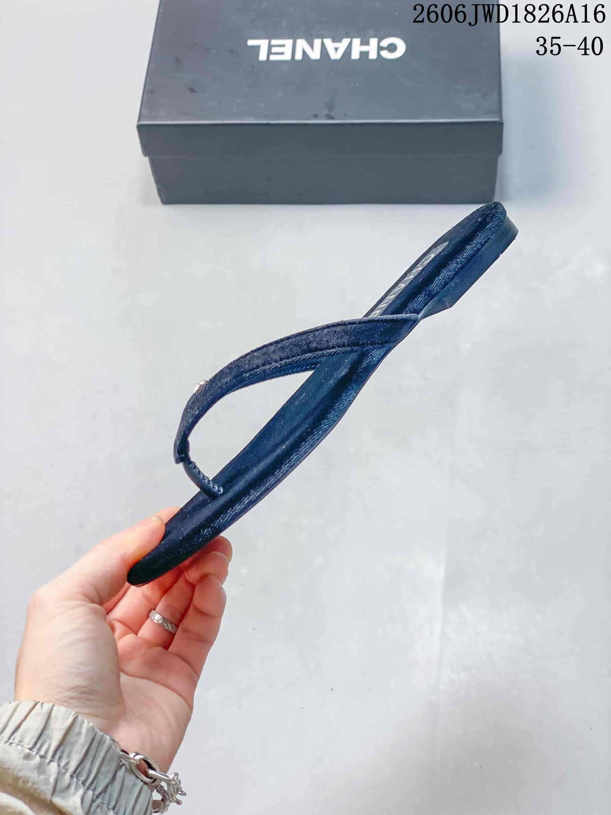 Side profile showing the low-profile sole and V-shaped strap of a navy thong sandal.