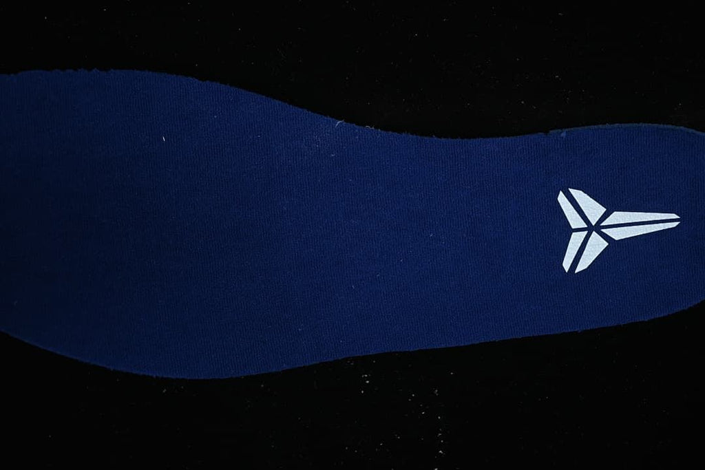 Close-up of a blue shoe insert with Kobe logo