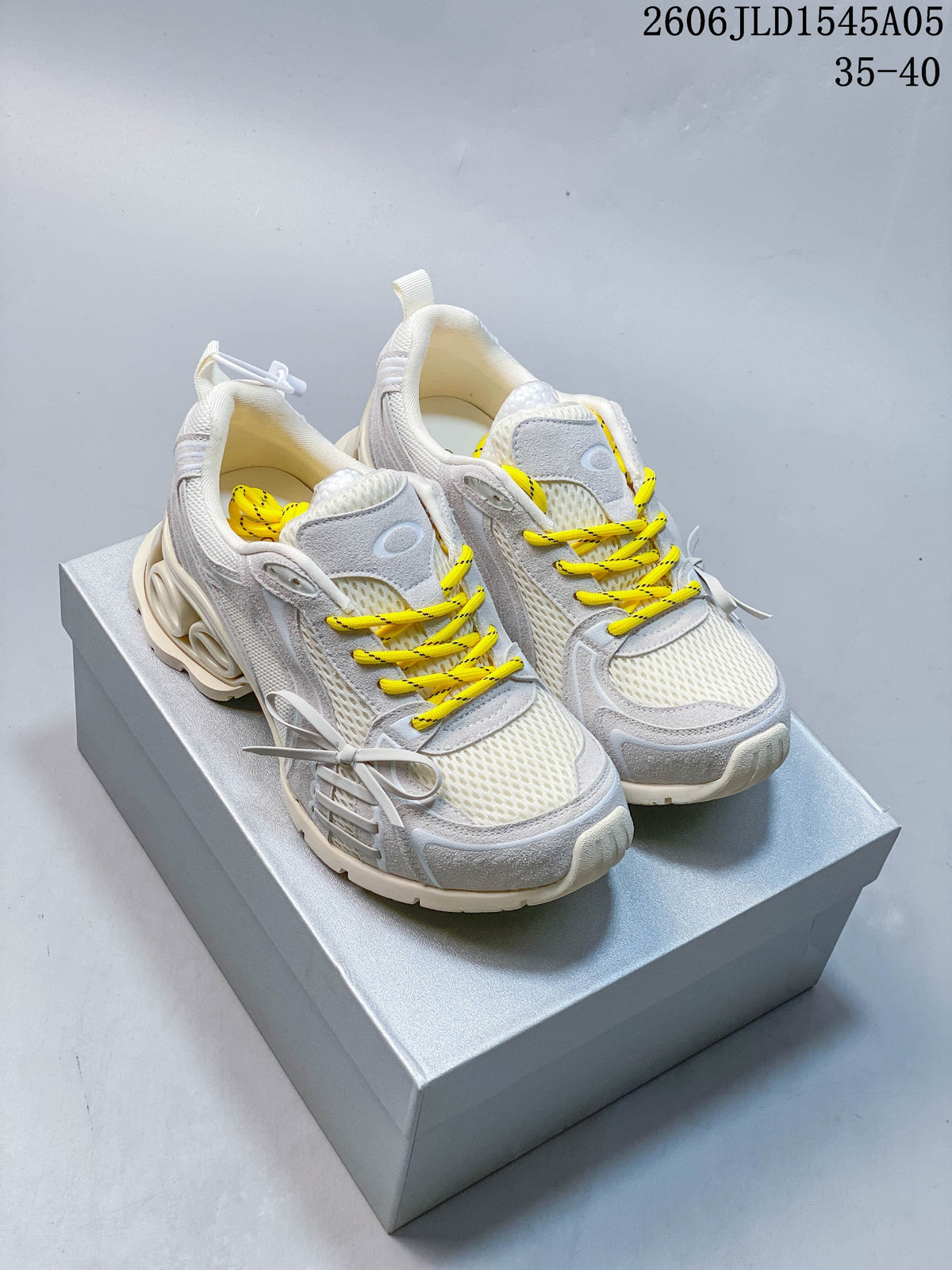 Pair of cream and light gray chunky sneakers with yellow laces and side bows