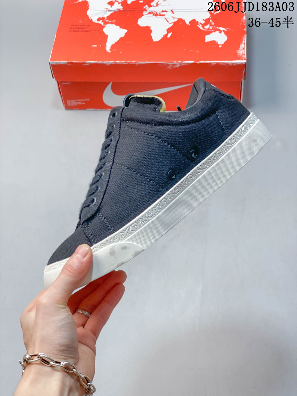 Side view of a navy low-top sneaker with a decorative white sole edge