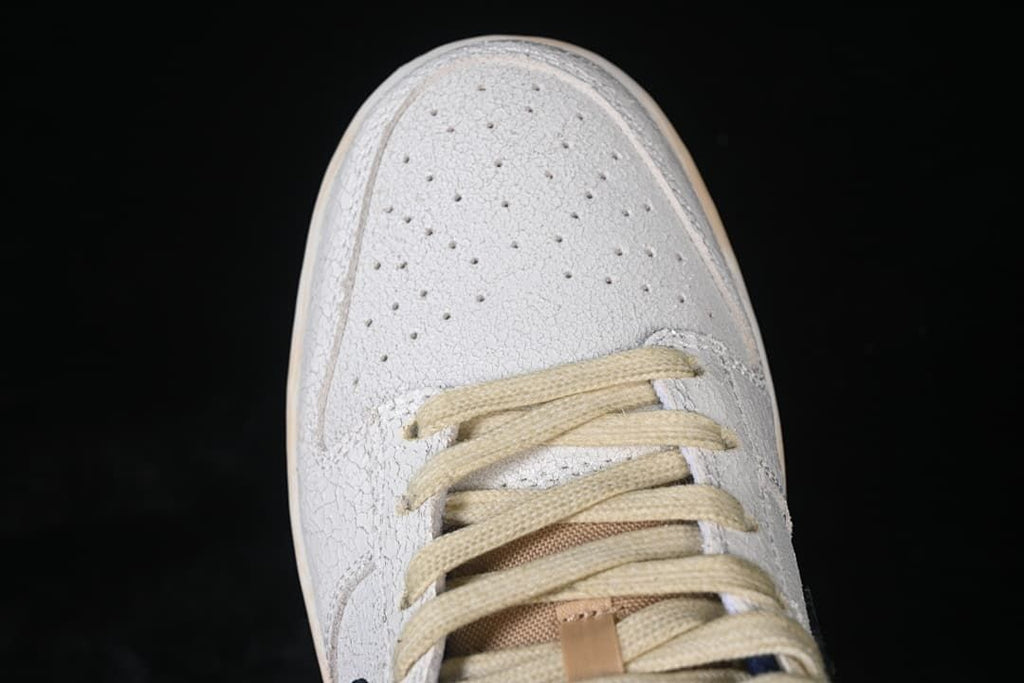 Top-down close-up of perforated toe box and cream laces