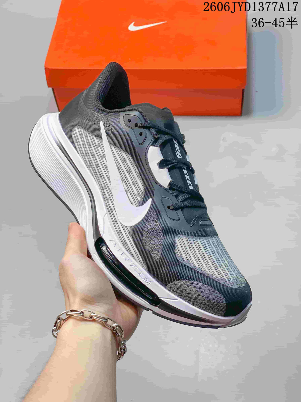 Angled side view of the charcoal and gray sneaker with white Swoosh and sole details