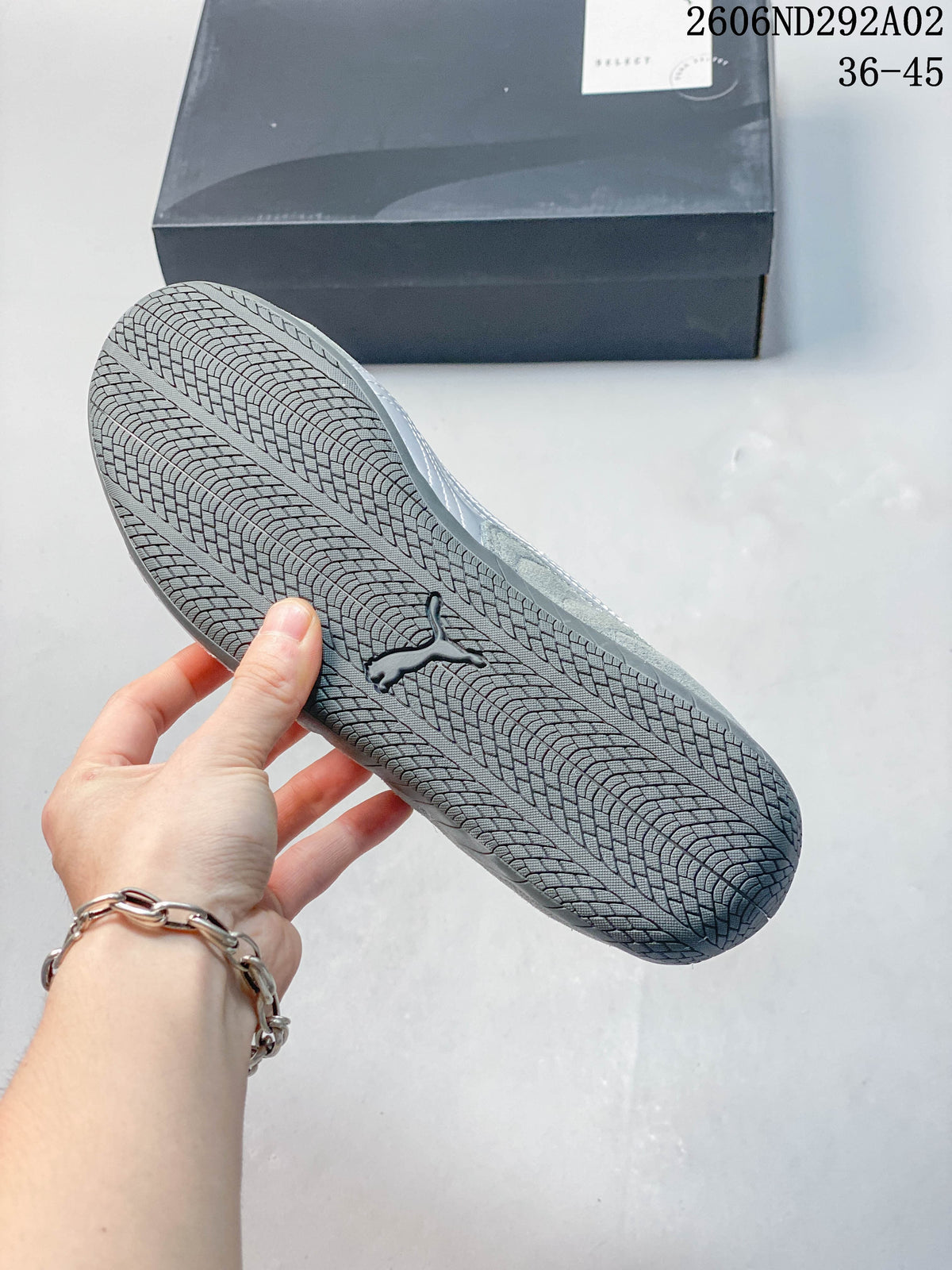 Close-up of the patterned outsole on a gray Puma sneaker