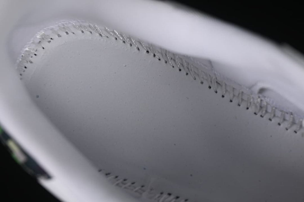 Close-up of stitching inside the white sneaker