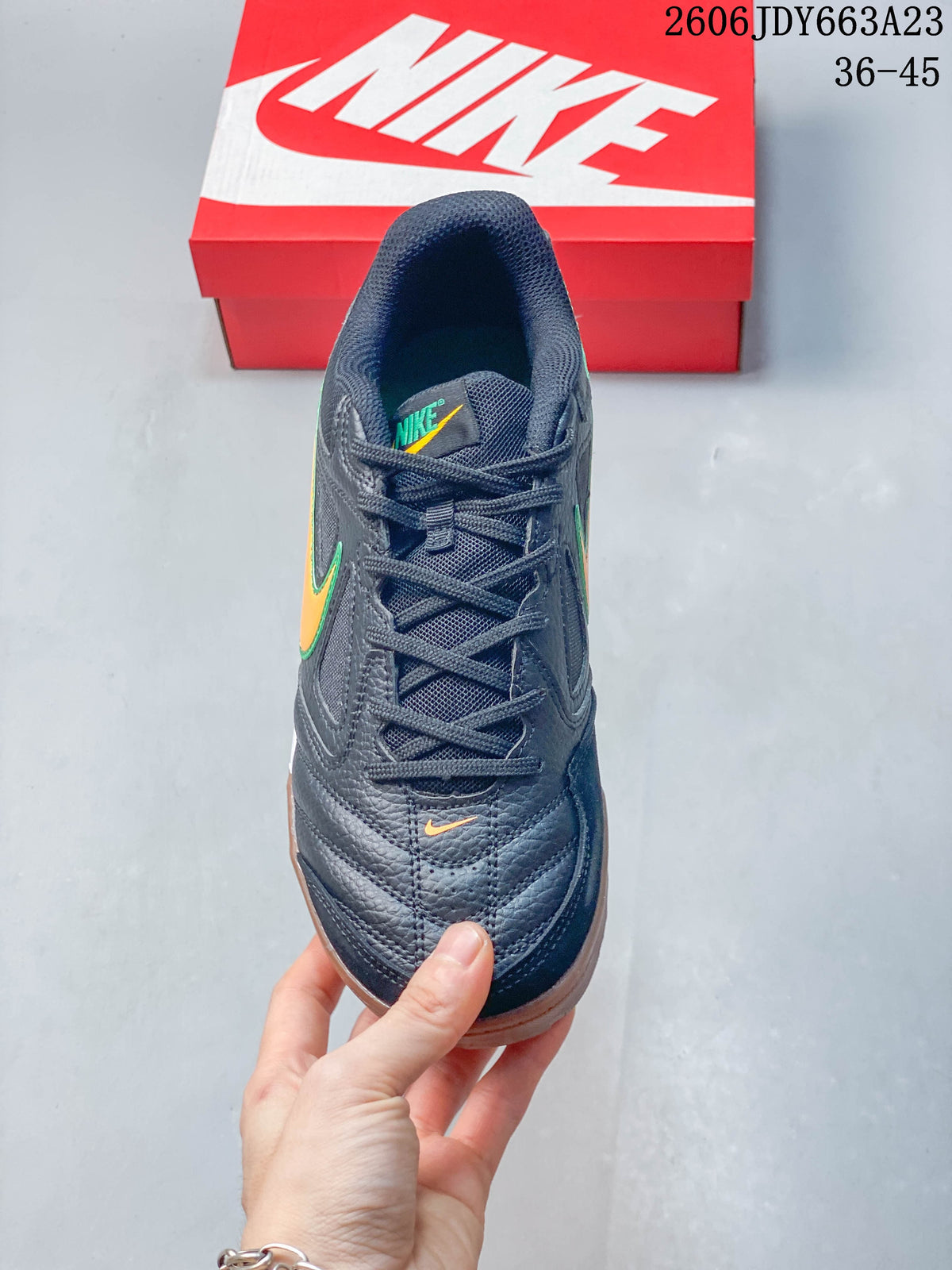 Top view of a dark lace-up sneaker with orange accents