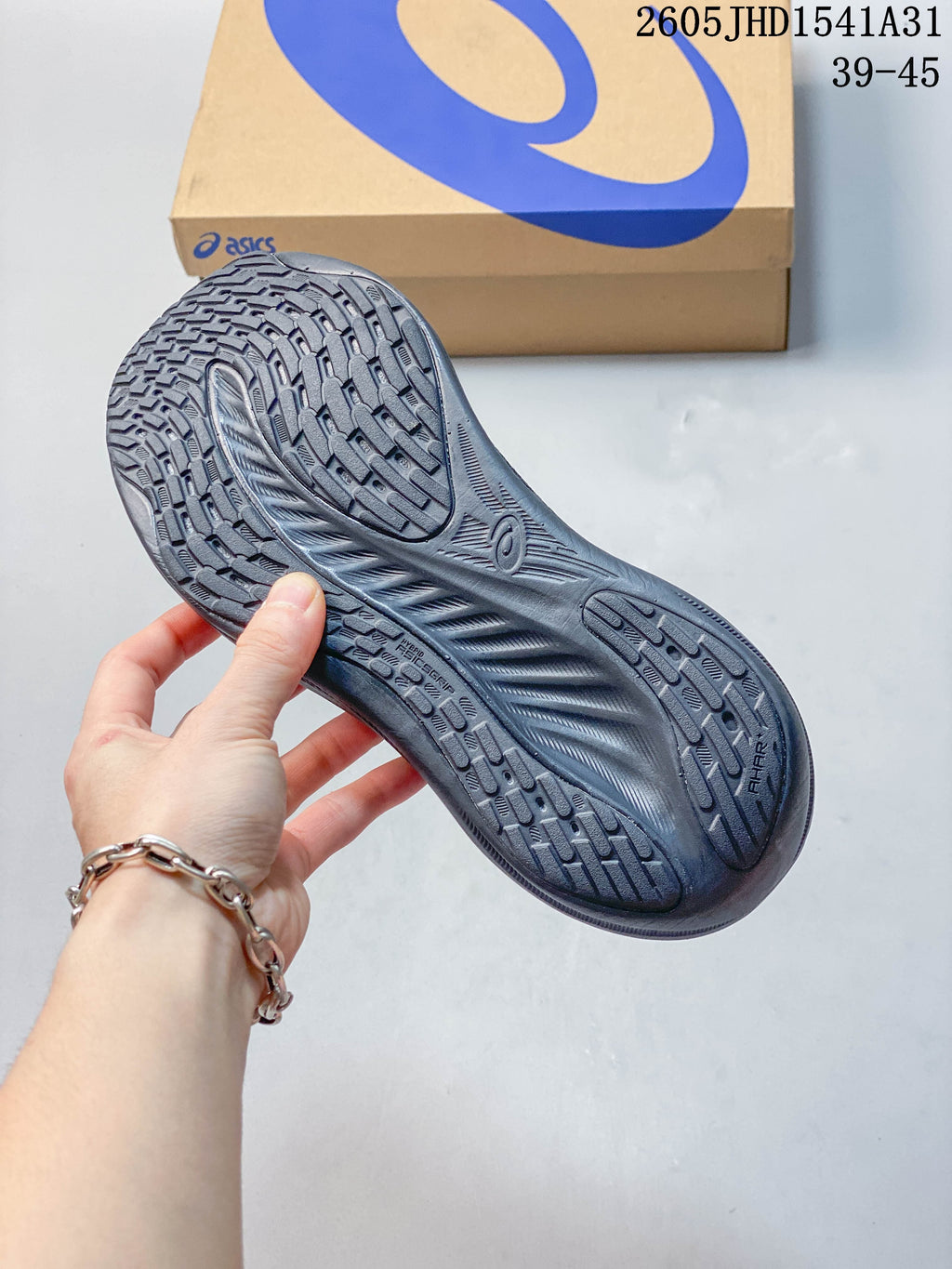 Outsole view of a dark gray ASICS GEL-NIMBUS 26 running shoe