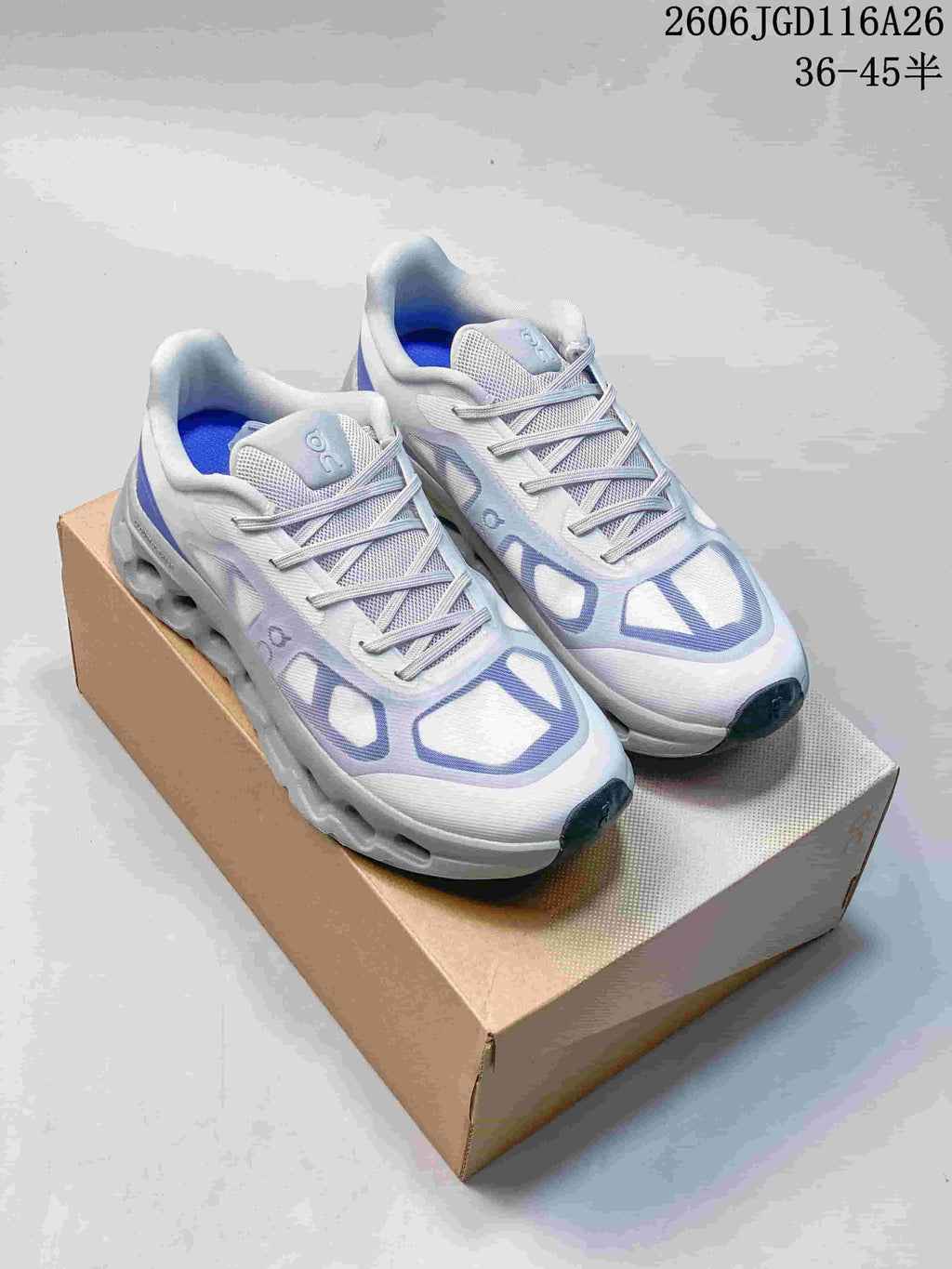 White On Cloudtilt Remix sneakers with lavender accents, shown on a shoebox.
