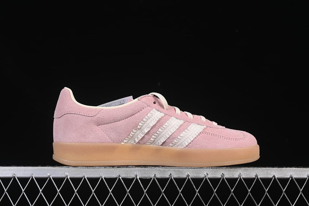 Side profile of the pink low-top sneaker with white stripes