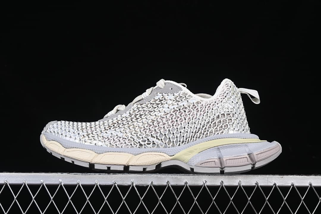 Side view of white and grey Balenciaga Phantom sneakers with an openwork upper and segmented sole