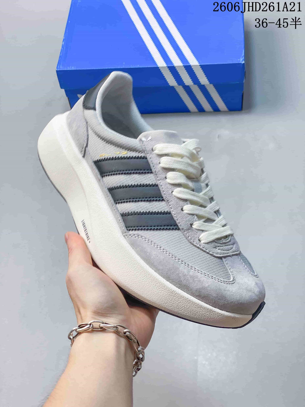 Side profile of a grey adidas Originals SL 72 Pro sneaker with dark stripes