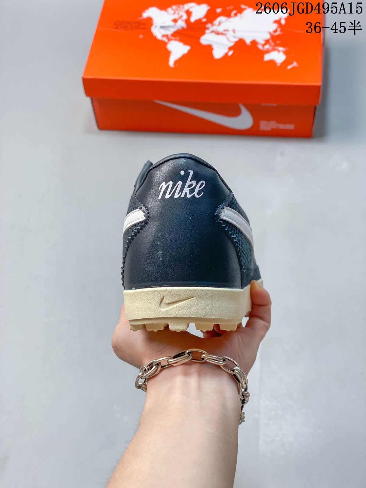 Rear view of a dark navy Nike Astro Grabber sneaker with cream-colored heel sole.