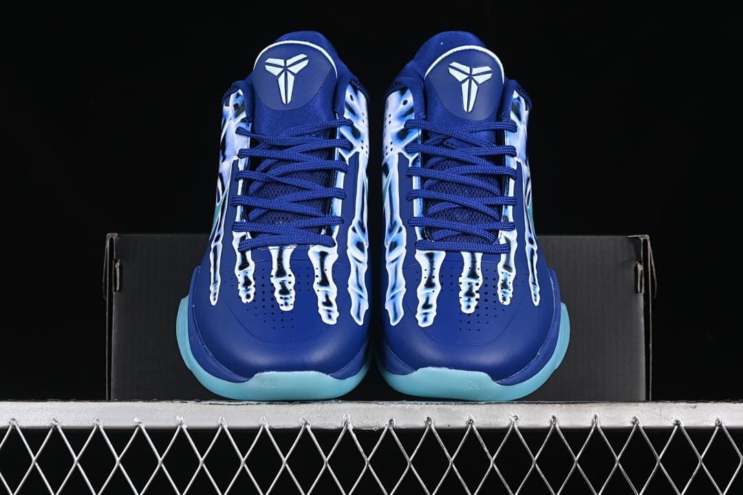 Front view of the pair showing tongue emblems, laces, and aqua outsole edges