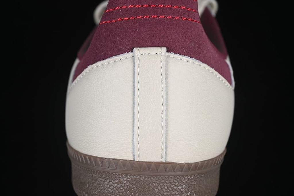 Rear close-up showing cream heel panels, burgundy heel tabs, and brown outsole.