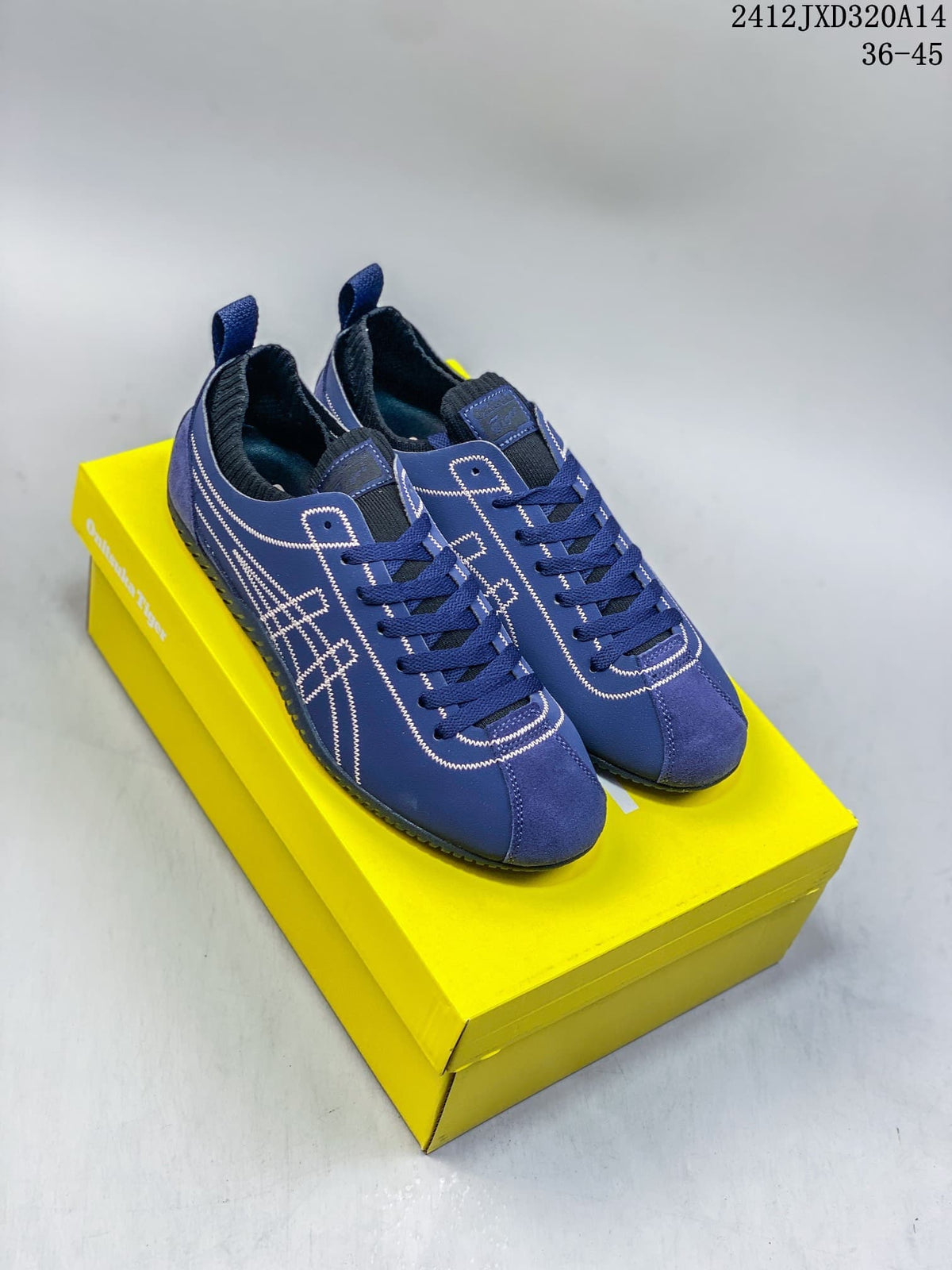 Pair of blue Onitsuka Tiger SCLAW low-top sneakers on a yellow box