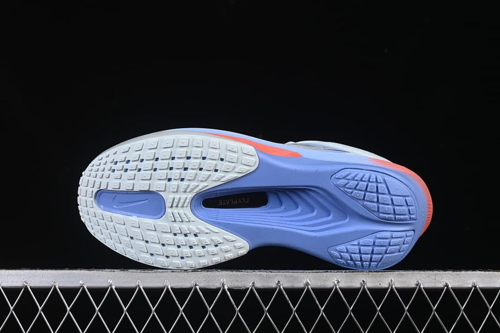 Underside of the shoe showing patterned outsole sections in white and violet.