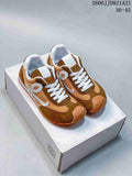 Pair of brown and tan mesh retro sneakers with white laces and orange-toned soles