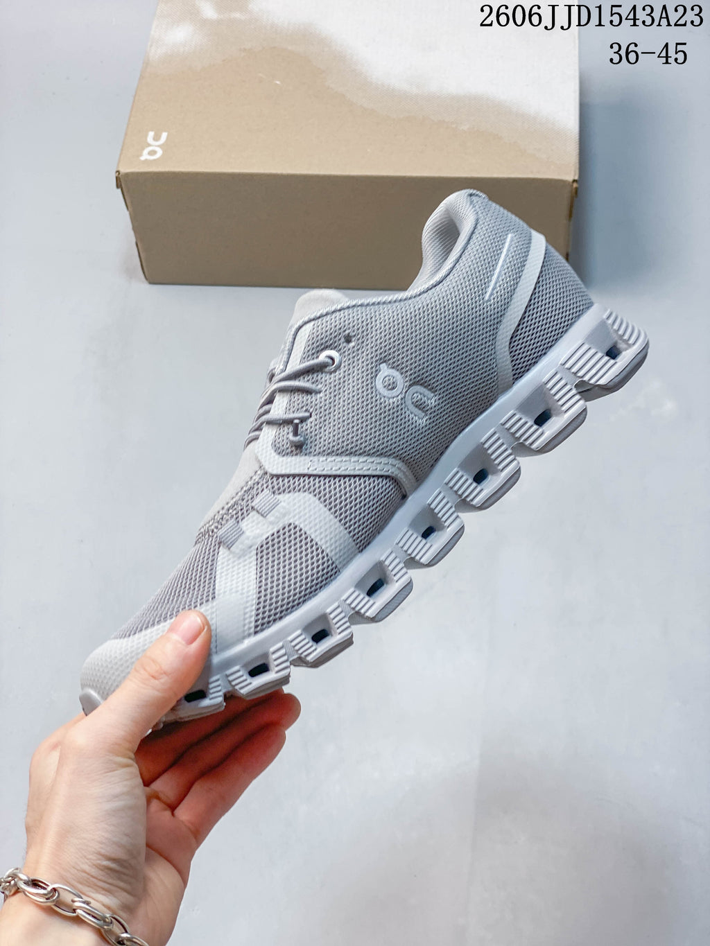 Side view of a grey sneaker with a segmented outsole.