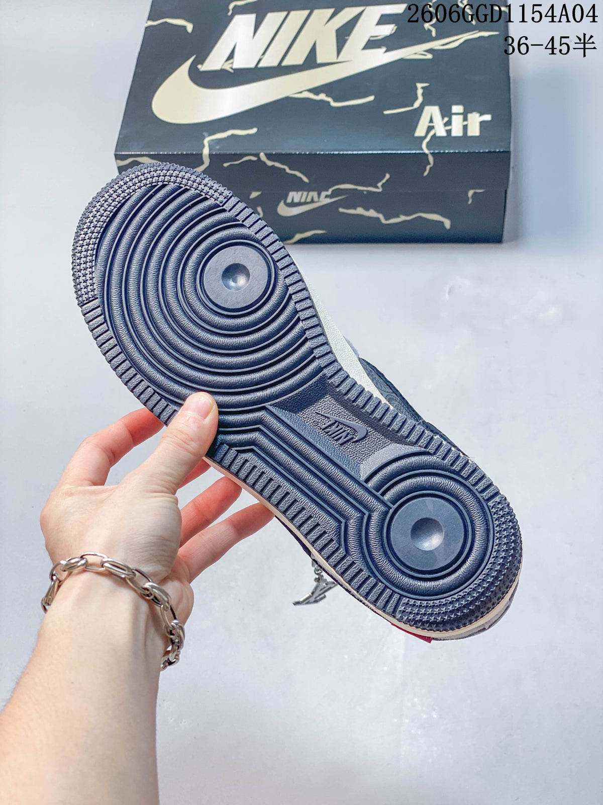 Close-up of the dark treaded outsole on the grey and navy sneaker