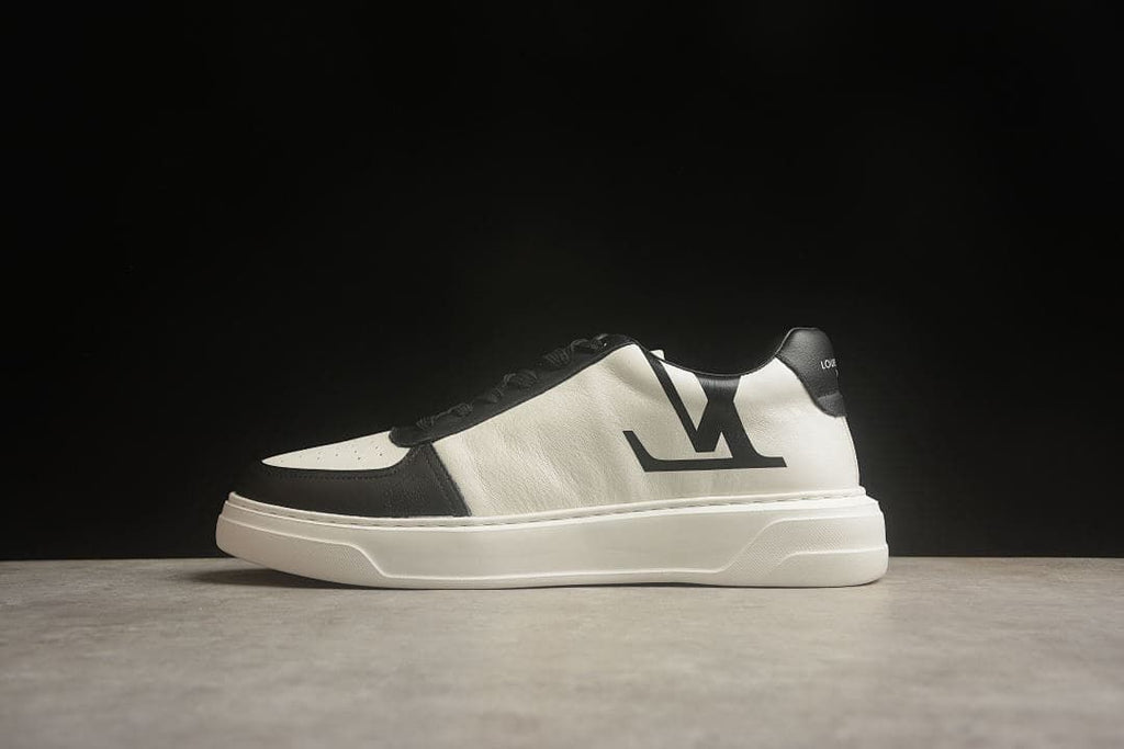 Side view of a black-and-white low-top sneaker with a prominent side logo and thick white sole